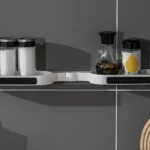 Estante giratorio para baño con especias y condimentos en recipientes de vidrio.