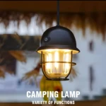 Lámpara de camping negra colgante, linterna LED recargable con cristal transparente y detalles metálicos.