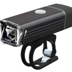 Luz frontal recargable USB para bicicleta, negra, con soporte de montaje.