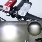 Luz LED recargable USB para bicicleta, color rojo y plateado, con haz controlado.