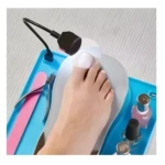 Mesa para pedicure con lámpara LED, limas, cortaúñas y esmaltes para uñas de pies.