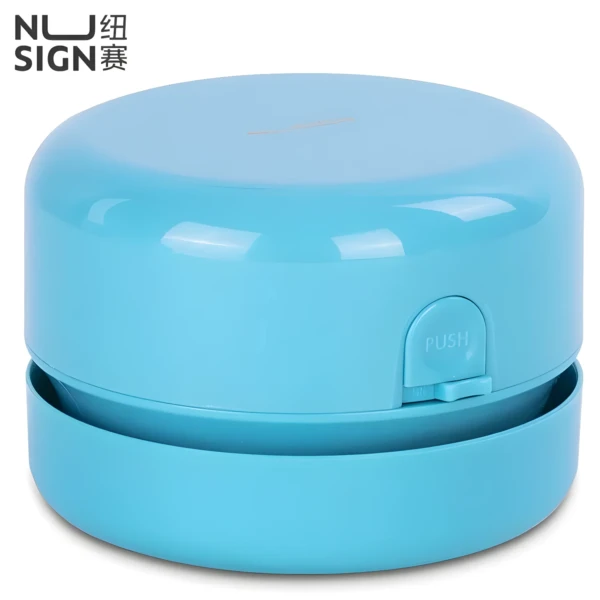 Mini aspiradora de escritorio inalámbrica azul con botón "PUSH" y logo NU SIGN.