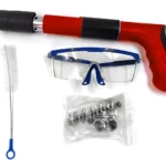 Pistola neumática para clavos de acero, incluye gafas de seguridad y repuestos.