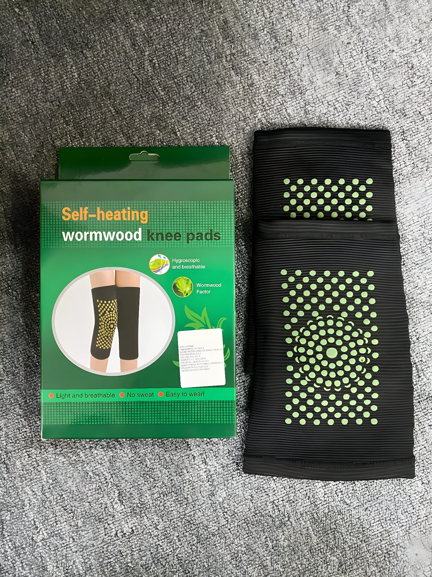 Rodilleras elásticas negras con puntos verdes autocalentables de artemisa.