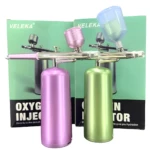 Aerógrafo inalámbrico portátil VELEKA en rosa y verde metálico, con dos recipientes de líquido y dos depósitos de aire.