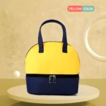 Bolso nevera amarillo y azul marino para leche materna, diseño con asas y doble compartimento.
