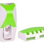 Dispensador automático de crema dental blanco y verde, con soporte para cepillos.