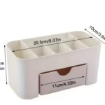 Organizador de maquillaje blanco con compartimentos, un cajón rosa y medidas indicadas.