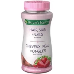 Frasco de 80 gomitas Nature's Bounty Hair, Skin & Nails con biotina, tapa rosa, etiqueta blanca con fresas y descripción en inglés y francés.