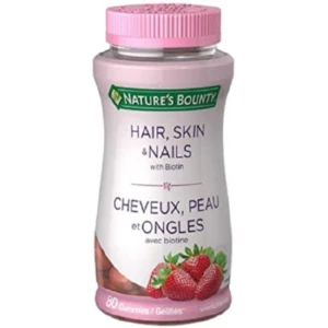 Frasco de 80 gomitas Nature's Bounty Hair, Skin & Nails con biotina, tapa rosa, etiqueta blanca con fresas y descripción en inglés y francés.