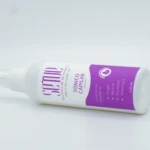 Tónico capilar Set x2 en envase blanco con etiquetas moradas, para anticaída y con extractos naturales.