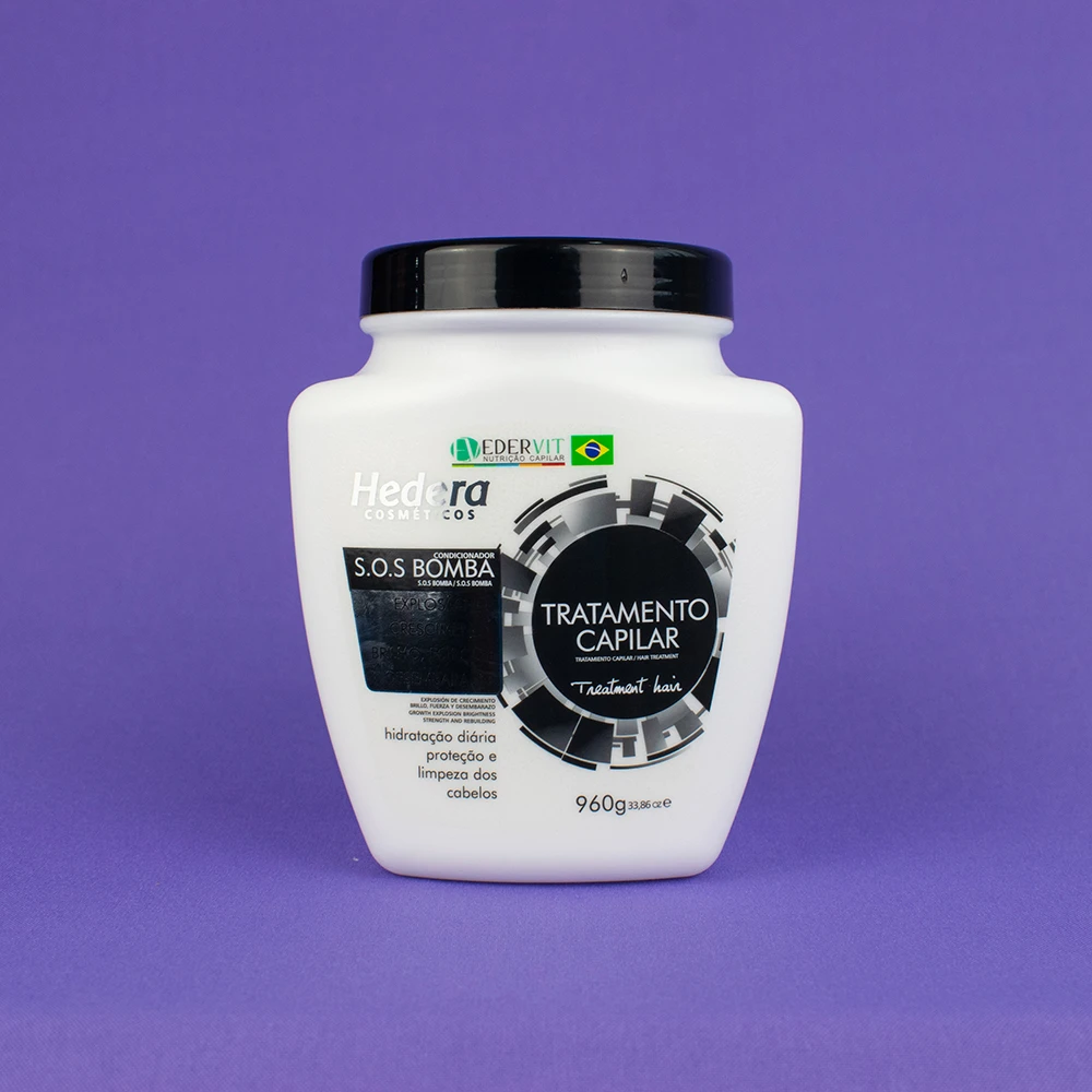 Envase blanco de tratamiento capilar S.O.S Bomba de 960gr, con tapa negra, fondo morado.