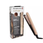 Plancha Remington Keratin Therapy color champán con placas de cerámica, expuesta junto a su empaque informativo que destaca tecnología de aceite de argán.