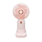 Mini ventilador portátil rosa con detalles dorados y luz indicadora.