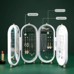 Joyero organizador de joyas blanco y transparente tipo tríptico con espejo y separadores para aretes, collares y pulseras.