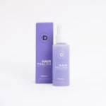 Bruma exfoliante capilar Divanti Beauty, envase púrpura, para renovar el cuero cabelludo.