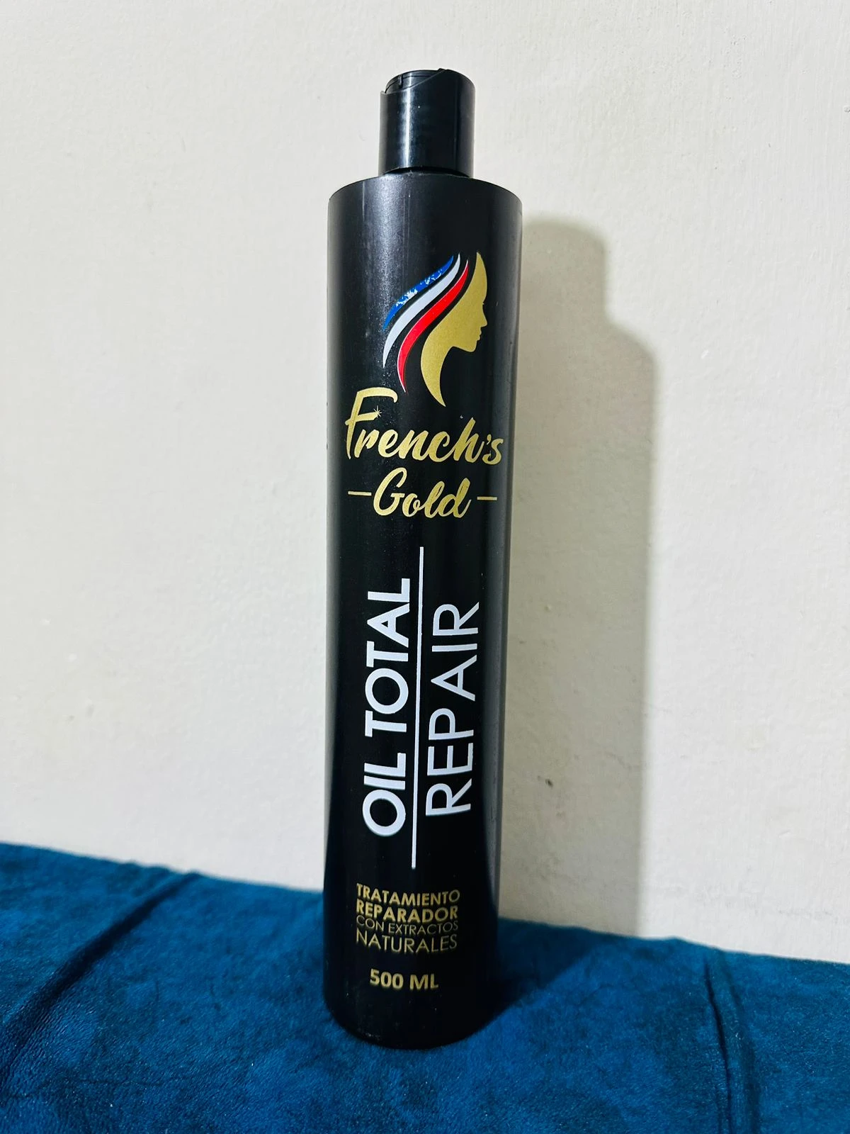 Botella negra de repolarizador capilar French's Gold Oil Total Repair 500ml, tratamiento con extractos naturales.