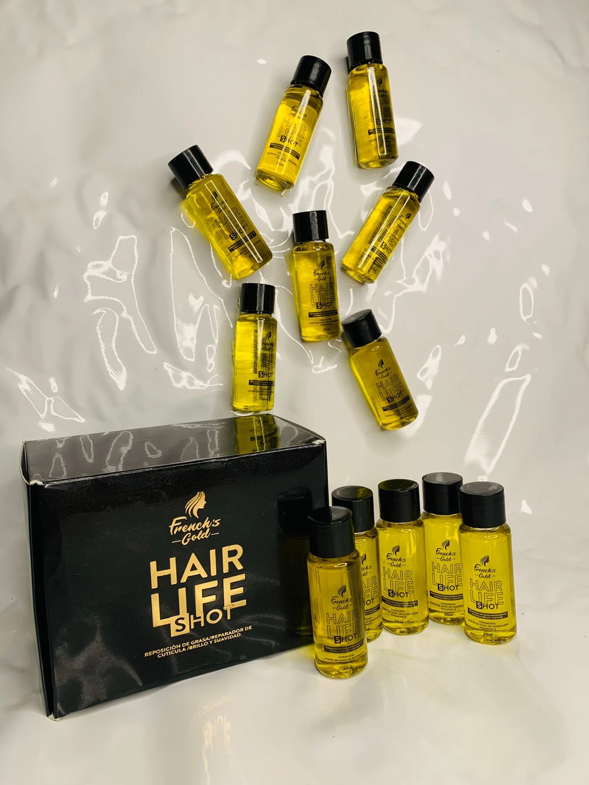 Caja de ampolletas "Hair Life Shot" de French's Gold con líquido capilar en frascos pequeños y envase negro.