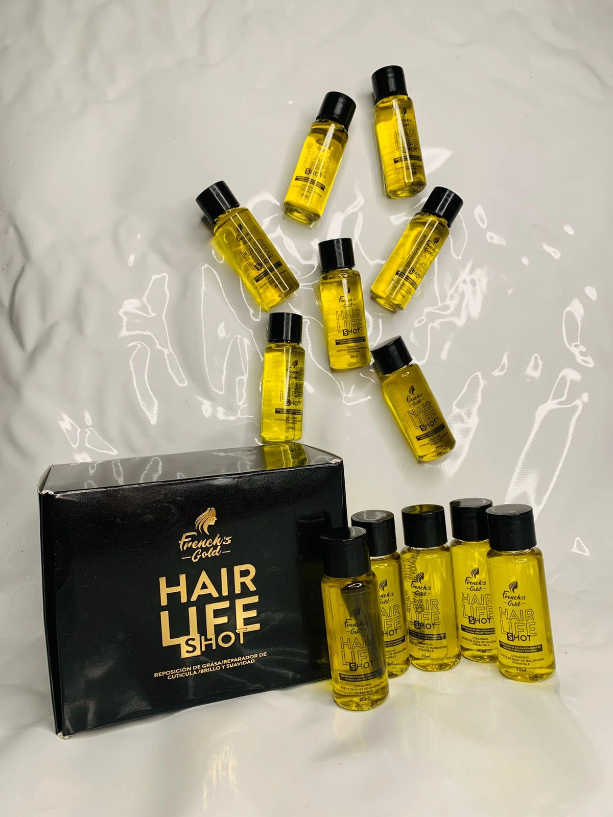 Caja negra con 12 ampolletas de aceite capilar "Hair Life Shot" French's Gold, para brillo y suavidad.