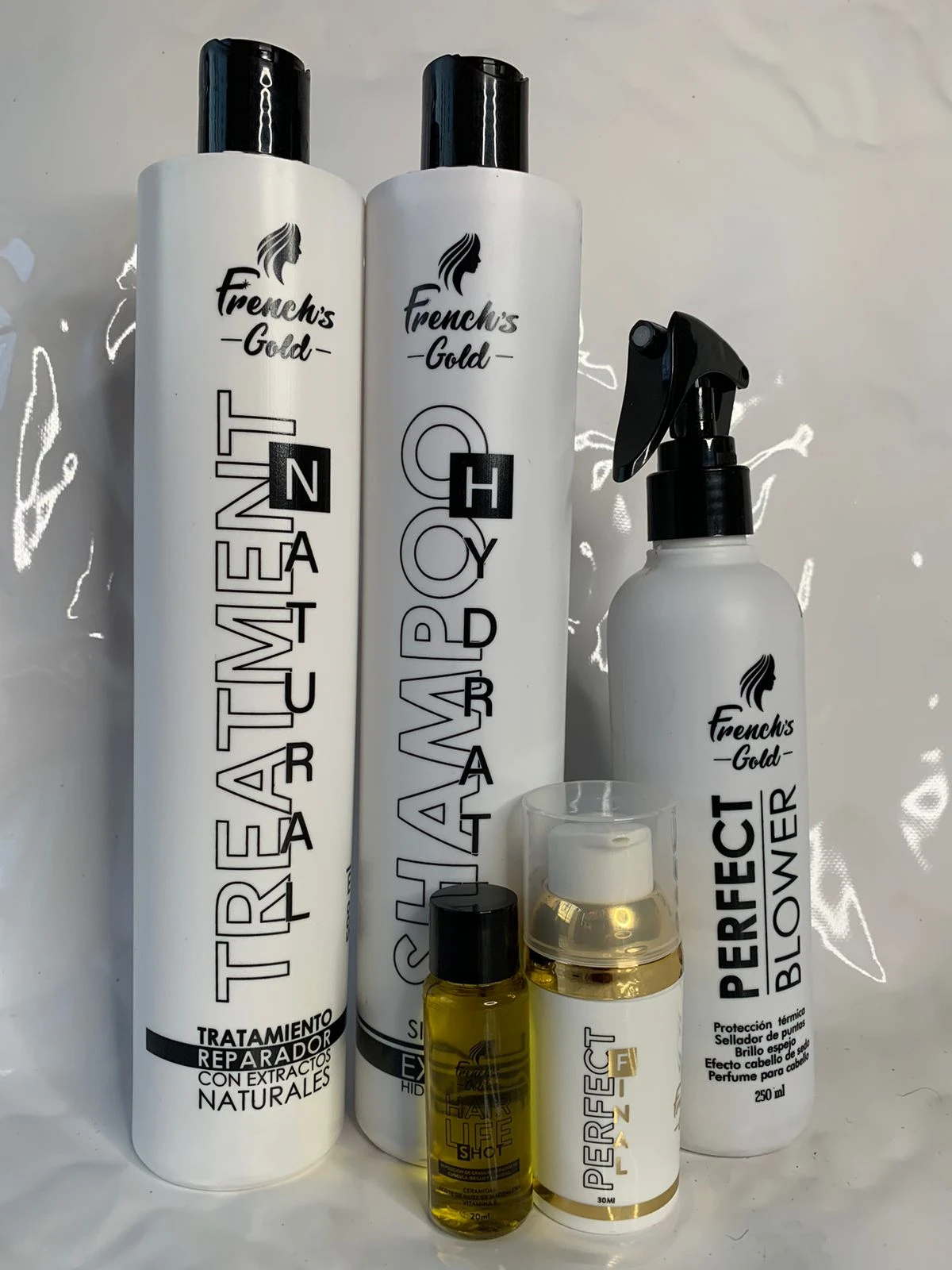 Set de productos para cabello French's Gold: shampoo, tratamiento, protector térmico y ampolleta.