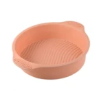 Molde de silicona rosado para freidora de aire, diseño texturizado y asas.