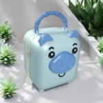 Alcancia azul con forma de cerdito, asa y llave, rodeada de suculentas.