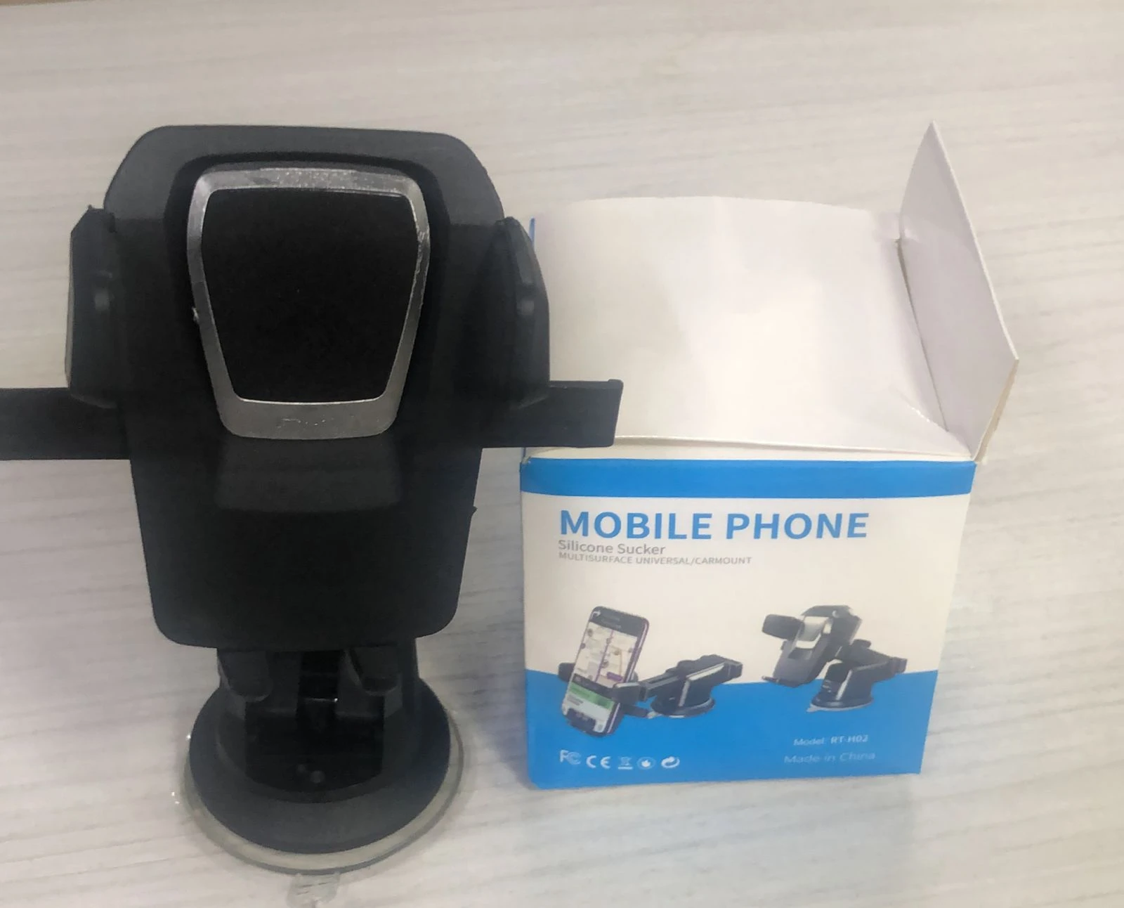 Soporte universal para celular, negro, con ventosa y caja de embalaje.
