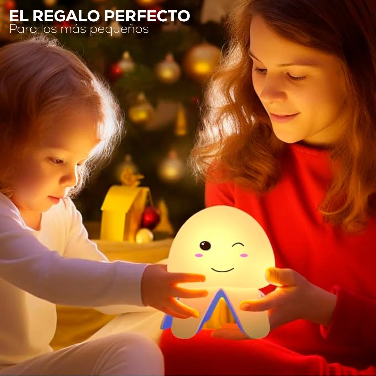 Lámpara de noche tipo medusa con función de ruido blanco, diseño de silicona suave con carita feliz, iluminada en ambiente cálido junto a dos personas.