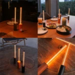 Mini lámpara minimalista de ambiente en colores negro y naranja con tubo iluminado, ideal para mesas de comedor o uso decorativo en interiores.