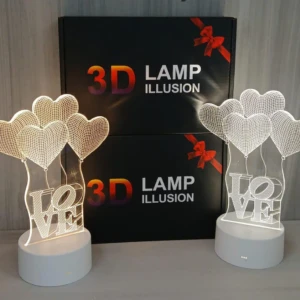 Lámpara decorativa 3D de corazones y palabra "LOVE" con base blanca, ideal para regalo.