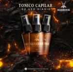 Tres frascos de tónico capilar de 30 ml con atomizador sobre fondo de roca volcánica ardiente, marca Markhor, para el uso diario en cabello y barba.