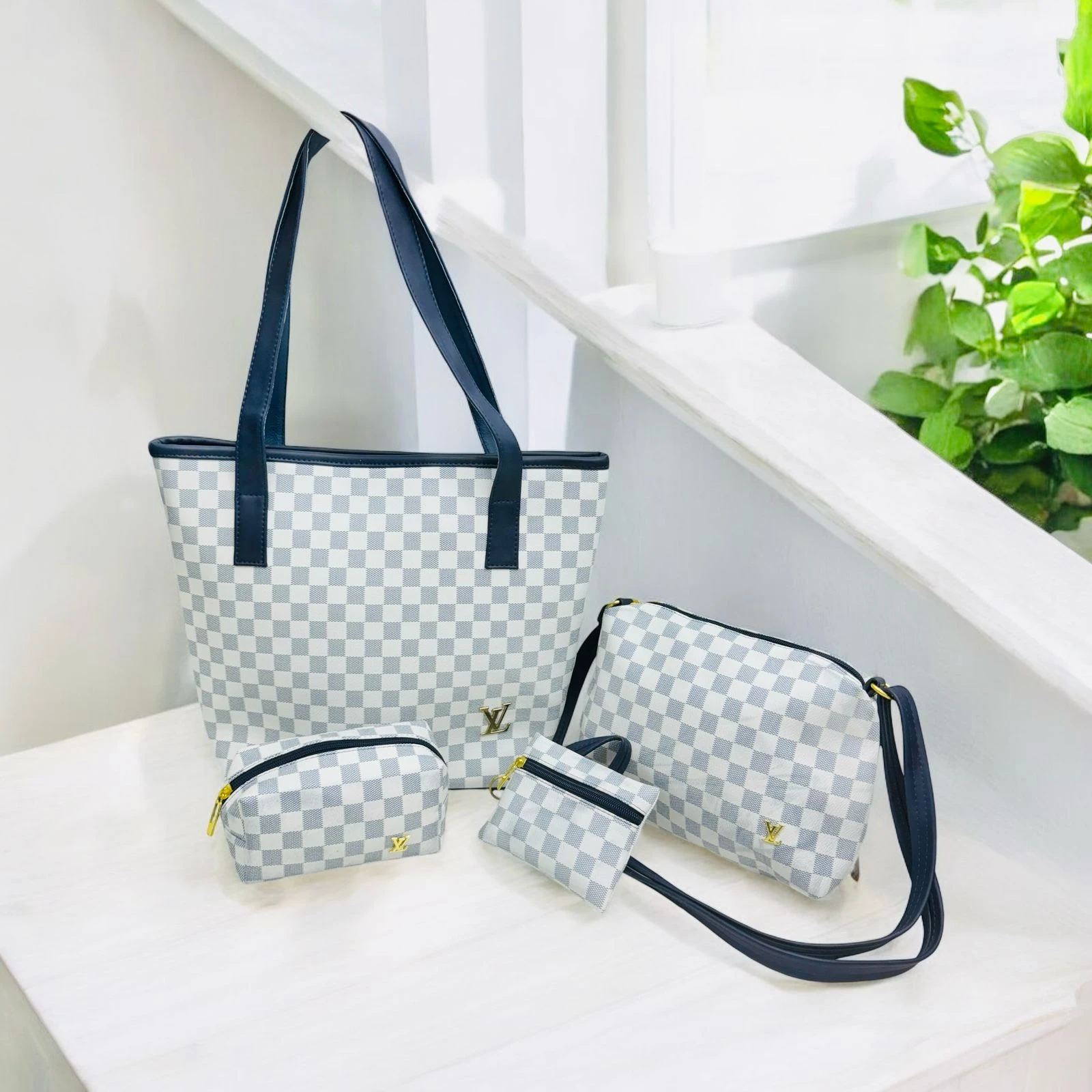 Juego de 4 bolsos Louis Vuitton Damier Azur: tote grande, bandolera mediana y dos estuches pequeños, con detalles azul marino y herrajes dorados.