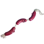 Juguete interactivo para perro, cuerda con tres salchichas rojas de goma con rostros sonrientes.