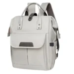 Pañalera morral gris claro con solapa frontal y compartimentos.
