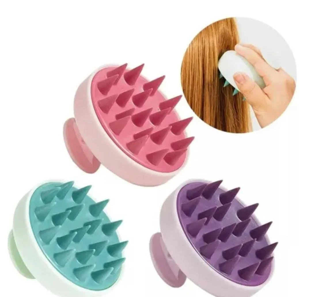 Cepillo masajeador capilar en colores rosa, turquesa y morado. Ideal para estimular el cuero cabelludo.