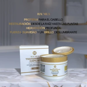 Tratamiento capilar de células madre Haumea en envase blanco y tapa dorada de 300ml, con su caja al lado sobre una superficie de mármol.