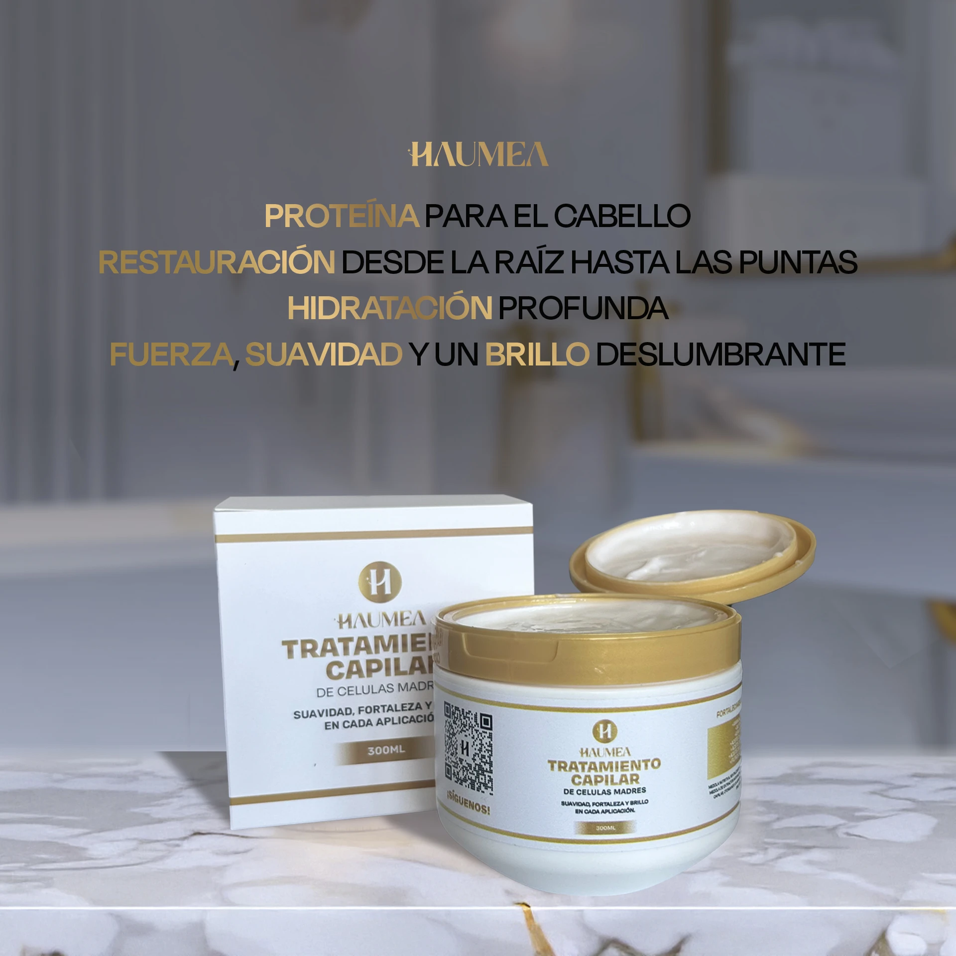Tratamiento capilar de células madre Haumea en envase blanco y tapa dorada de 300ml, con su caja al lado sobre una superficie de mármol.