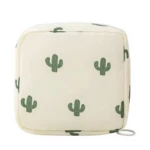 Cosmetiquera beige con estampado de cactus verdes, diseño cúbico, ideal para organizar.