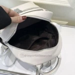 Morral blanco abierto, se aprecian compartimentos interiores y correas.