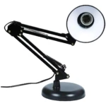 Lámpara de mesa ajustable, brazo articulado negro con resortes expuestos y base redonda, pantalla blanca interior para foco.