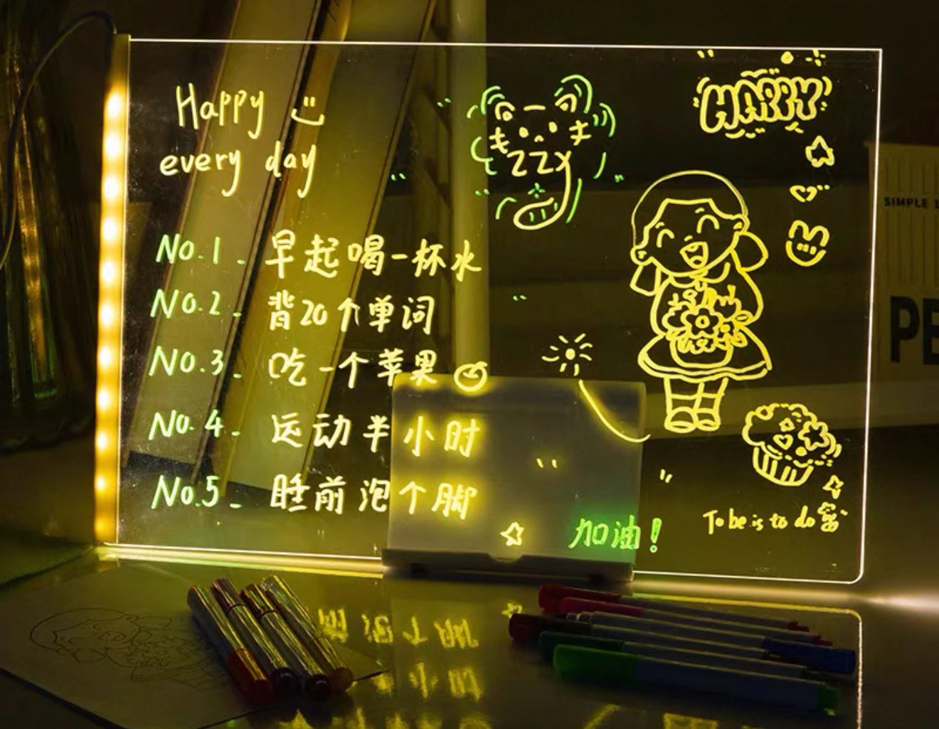 Tablero acrílico luminoso con mensajes y dibujos, ideal para escribir tareas o recordatorios diarios.