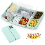 Pastillero magnético verde menta, set de 2, 7 compartimientos con pastillas surtidas y blíster.