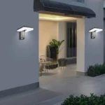 Lámpara solar de pared LED exterior gris, con sensor de movimiento, ilumina entrada de casa.