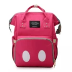 Morral pañalera rosa fucsia con diseño de lunares blancos frontales, estilo "Mickey Mouse", etiqueta "Living Traveling Share".