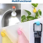 Ganchos adhesivos multifuncionales con forma de pulgar arriba en colores naranja, amarillo, rosa y azul, sujetando cepillo de cocina, planta, toallas y cinturón.