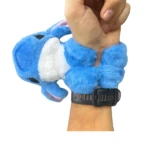 Manilla peluche azul Stitch con detalles blancos, ajustable con correa negra en muñeca.