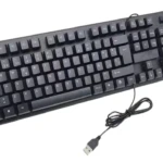 Teclado USB negro para PC con disposición española, vista superior con cable enrollado y conector.
