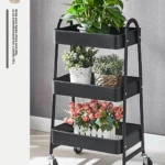 Organizador de cocina negro 3 niveles con plantas y flores decorativas.