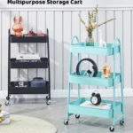 Carrito organizador metálico de 3 niveles en color azul menta con accesorios de decoración y libros.