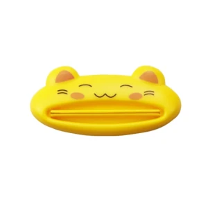 Exprimidor crema dental amarillo forma gatito sonriente para organizar baño.